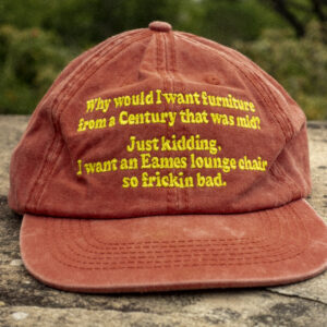 Faded burnt orange dad cap displaying the text, "Why would I want furniture from a century that was mid? Just Kidding. I want an Eames lounge chair so frickin bad." New cap, funny cap, camper cap, washed cotton, Irony, Humor, meme, Brass clasp.