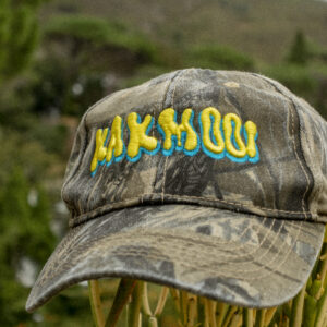 Faded olive green camo cap displaying the word "KAKMOOI" in a slimey font in 3D embroidery. Everyone loves a cool camouflage cap. New cap, funny cap, camper cap, washed cotton, Irony, Humor, meme. Hunting hat.