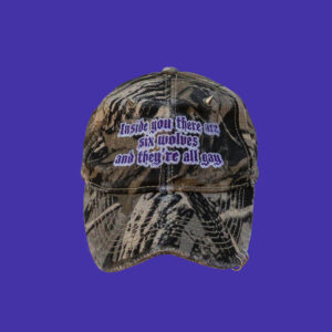 pierced and destressed camo cap with embroidery on the front